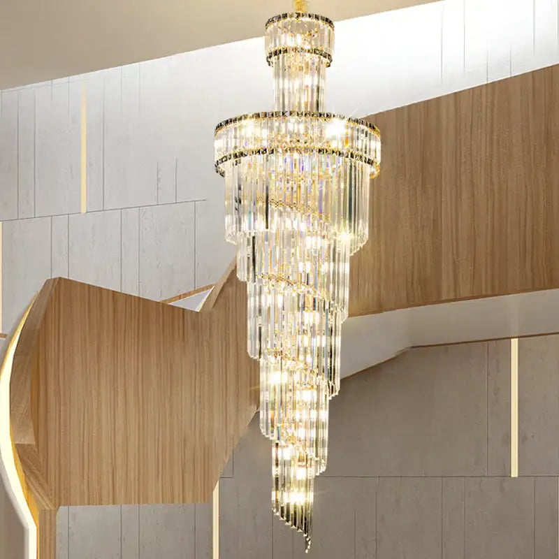 Decorbites crystal chandelier with gold-toned accents and cascading glass rods emitting warm glow for dining room