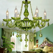 Emerald green decorbites crystal chandelier with crystal droplets and metallic accents for elegant lighting