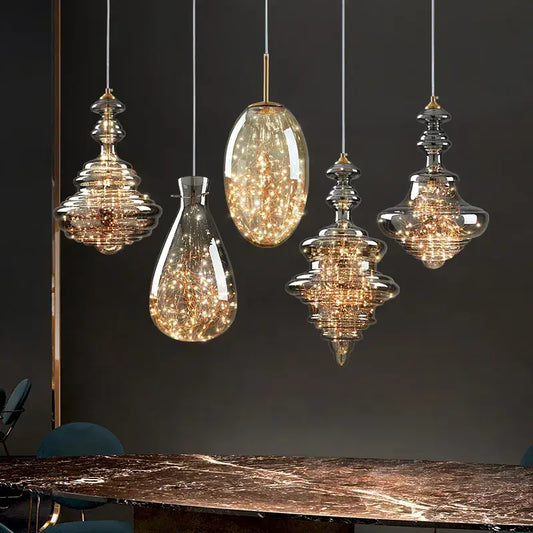 Five elegant glass pendant lights with glowing filaments in decorbites crystal chandelier for dining room decor