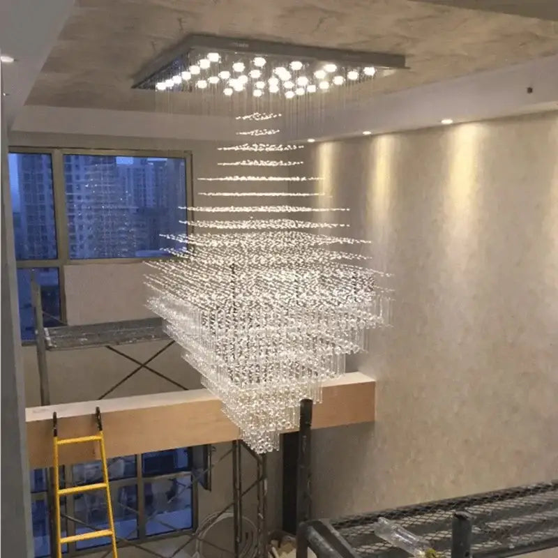 Modern multi-tiered decorbites crystal chandelier with square ceiling fixture and cascading glass for living room and lobby