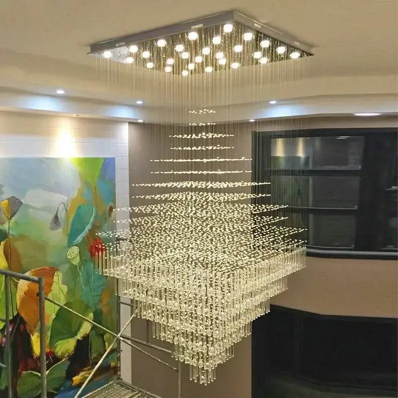 A modern decorbites crystal chandelier with cascading crystal droplets and square ceiling mount for living room and lobby