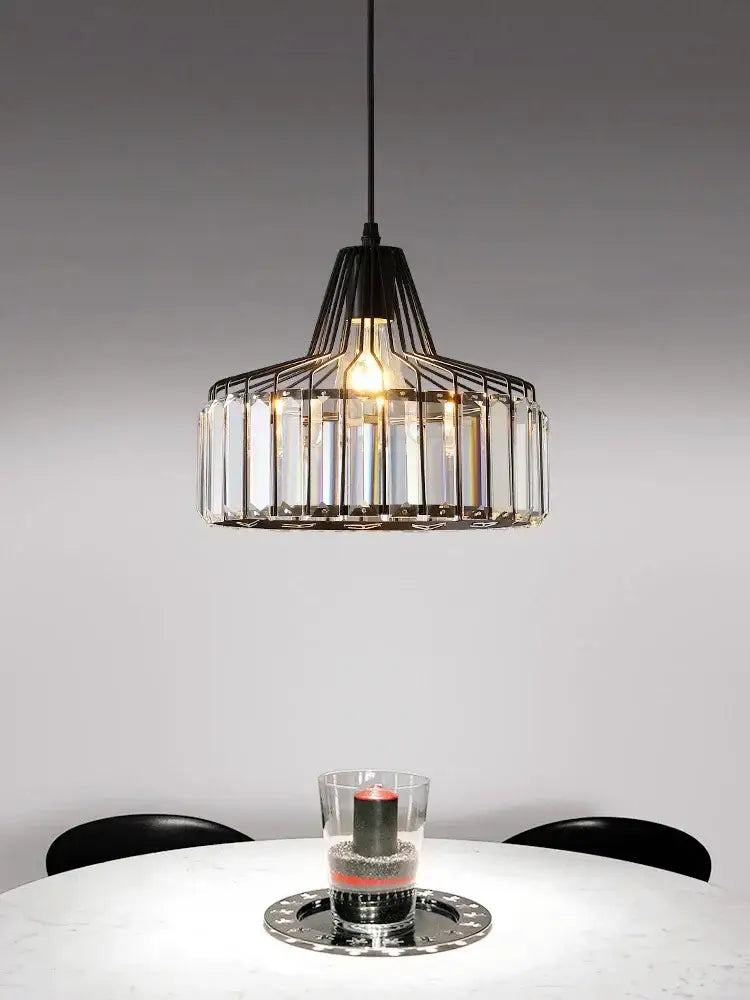 Black metal DecorBites crystal chandelier with clear crystal prisms pendant light above white table for elegant decor