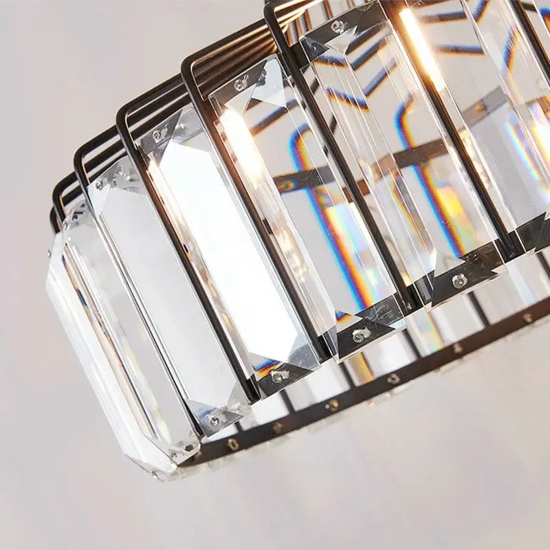A modern decorbites crystal chandelier pendant light with clear crystal bars in a black metal frame for elegant decor