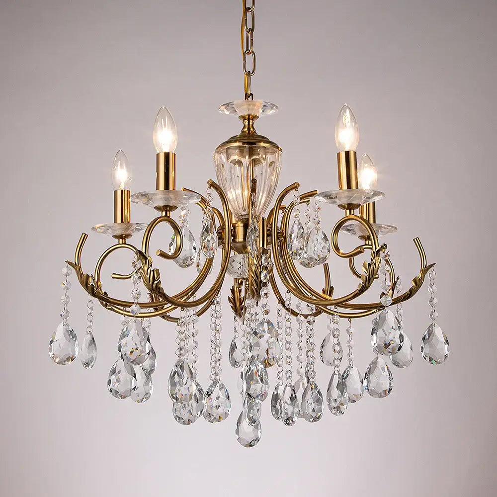 Gold-toned decorbites crystal chandelier with intricate curved arms and clear crystal droplets for luxury lighting