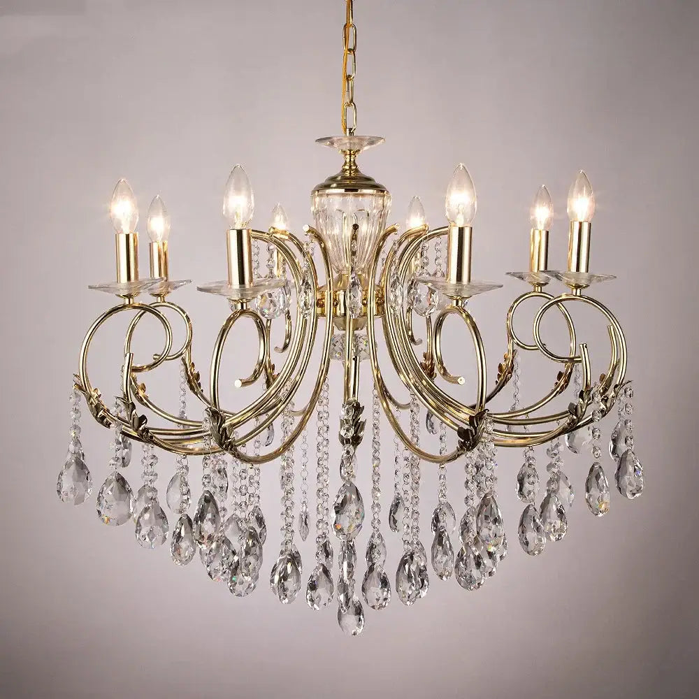 Gold-toned decorbites crystal chandelier with intricate curved arms clear crystal teardrop pendants and candle-style bulbs