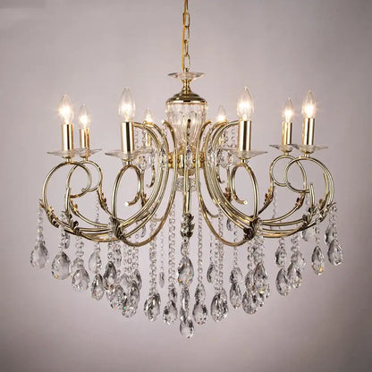 Gold-toned decorbites crystal chandelier with intricate curved arms clear crystal teardrop pendants and candle-style bulbs