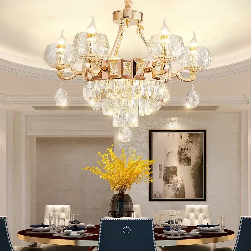 A luxurious gold-toned decorbites crystal chandelier with crystal droplets and faceted glass shades for grand european interiors