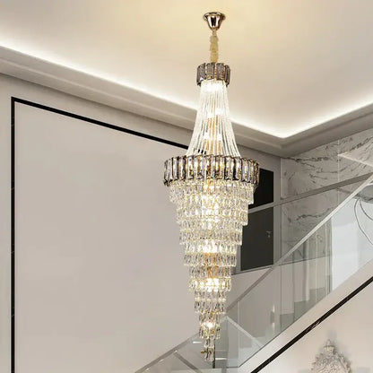 A DecorBites crystal chandelier with polished brass finish and clear faceted crystals for luxury duplex lighting