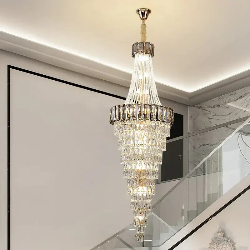 A DecorBites crystal chandelier with polished brass finish and clear faceted crystals for luxury duplex lighting