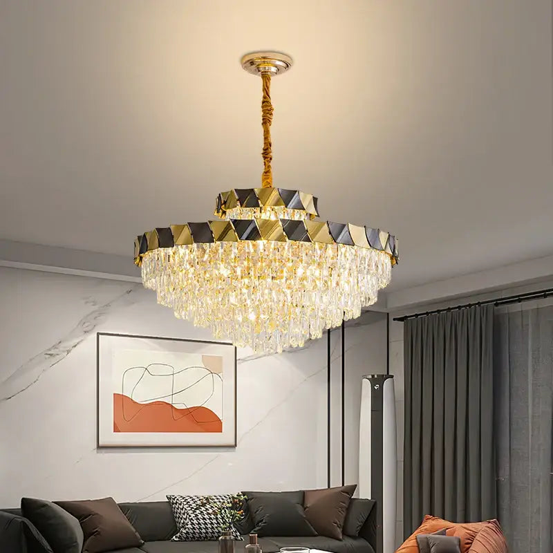 Gold-toned decorbites crystal chandelier with cascading crystal droplets and geometric frame for luxury lighting