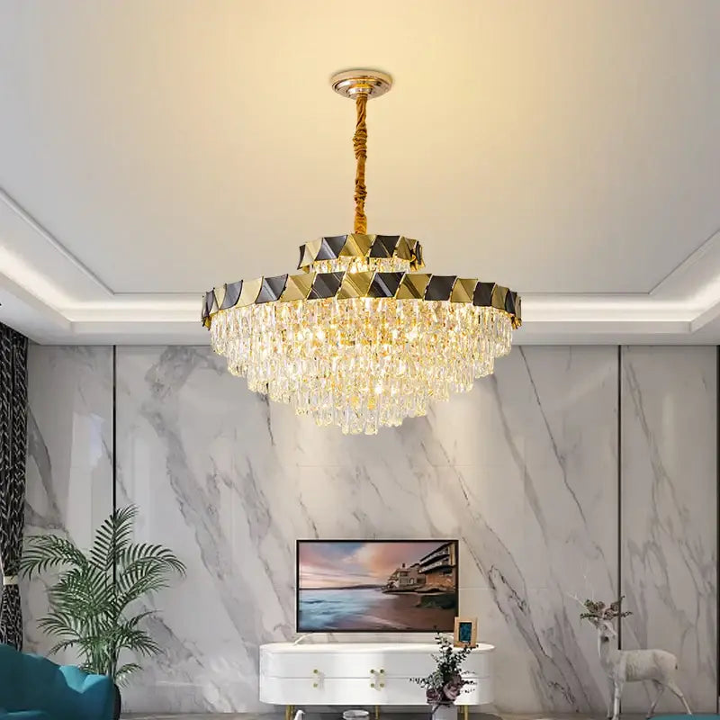 Gold-toned decorbites crystal chandelier with cascading droplets and geometric black and gold upper ring for luxury lighting