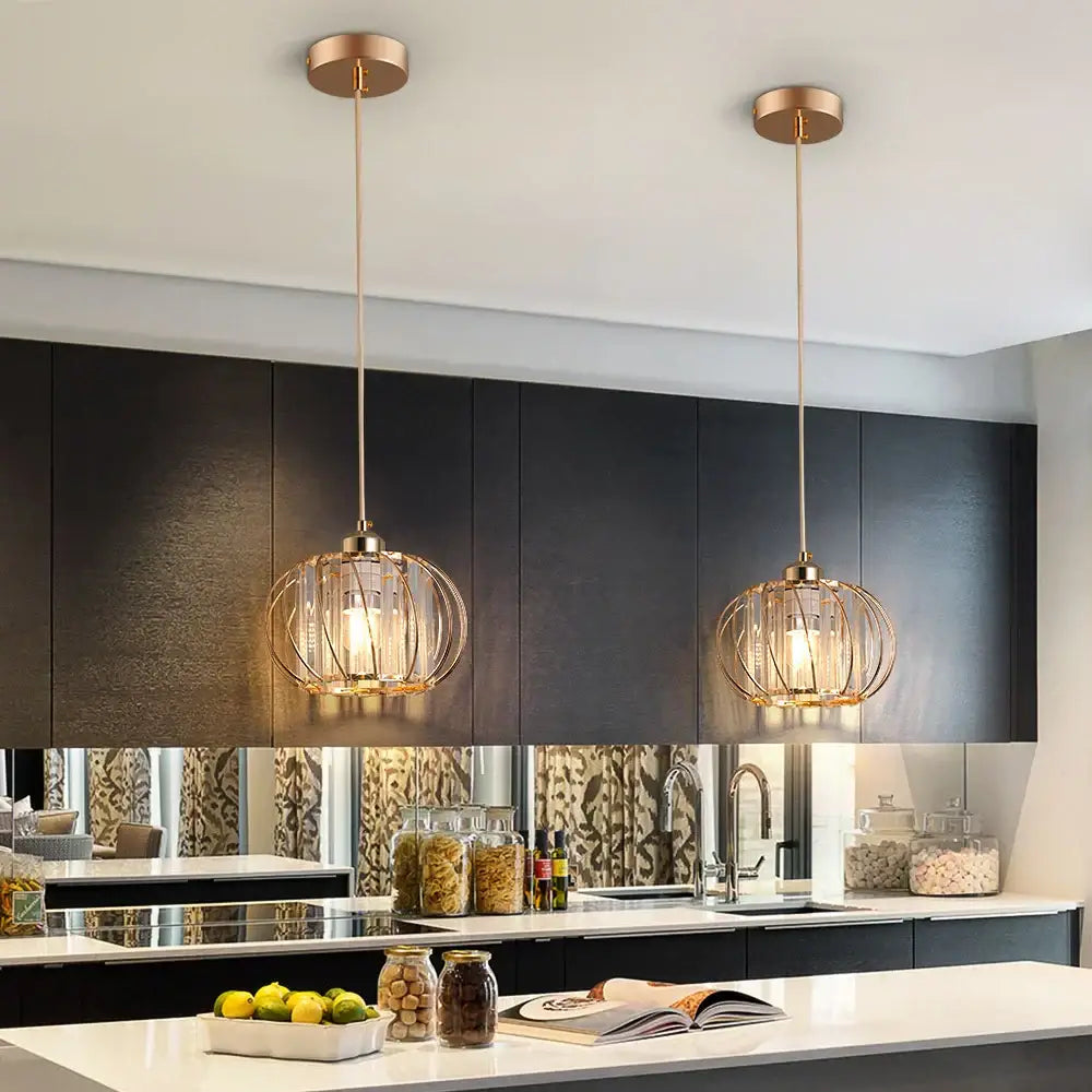 Two elegant gold-toned spherical cage pendant light fixtures with warm glow from DecorBites™ for modern décor