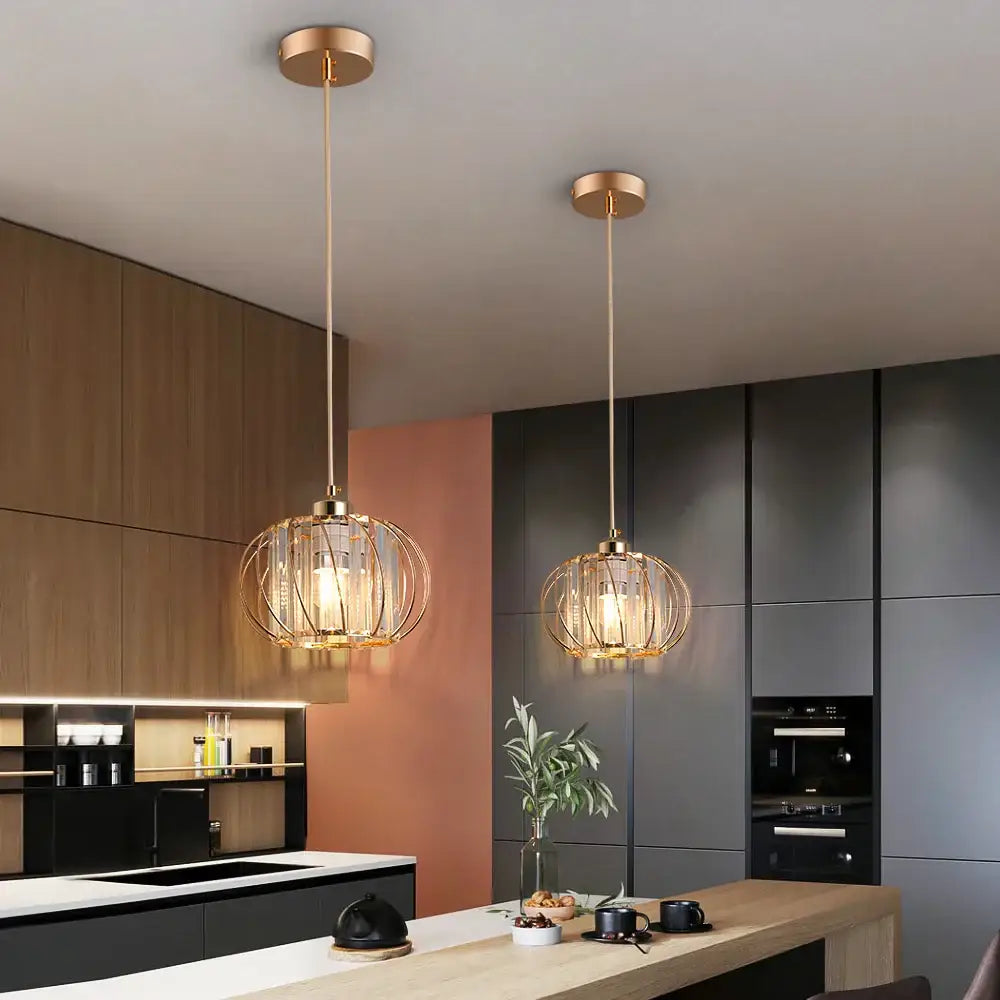 Two elegant gold-toned DecorBites™ pendant light fixtures feature intricate cage-like crystal glass shades for modern décor