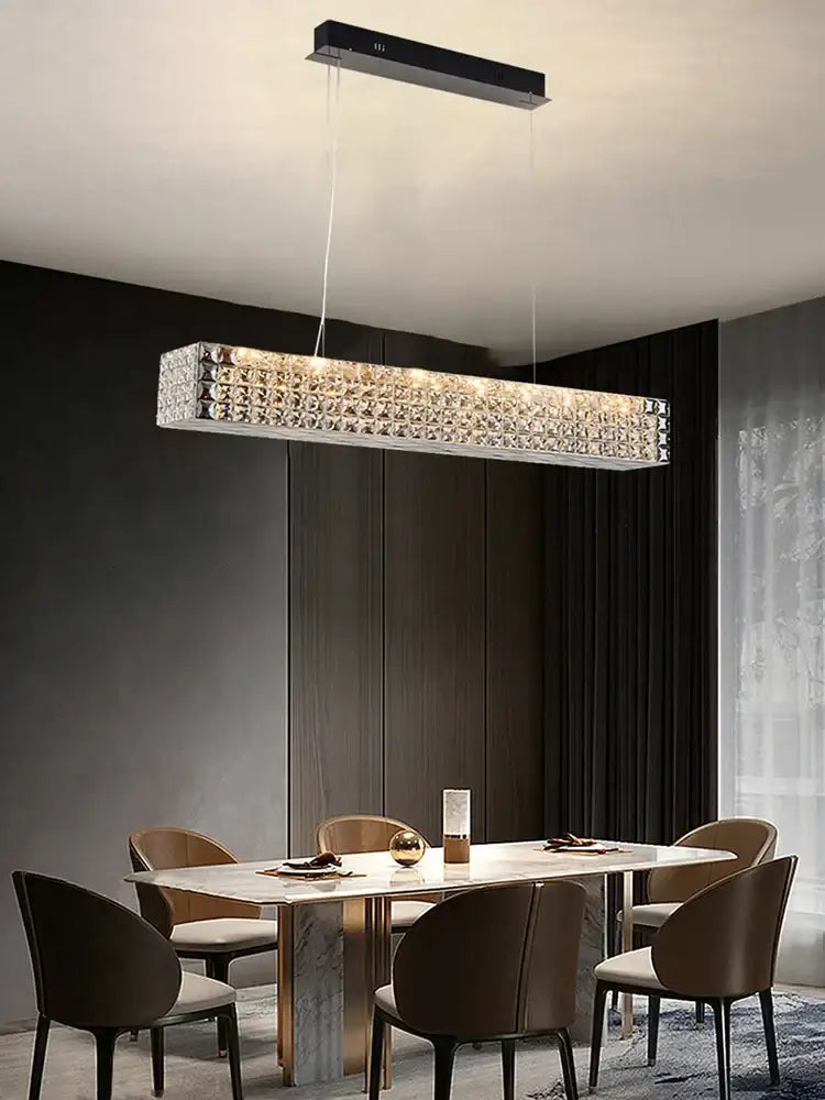 A sleek decorbites crystal chandelier with clear crystals in a polished silver frame for dining room lighting
