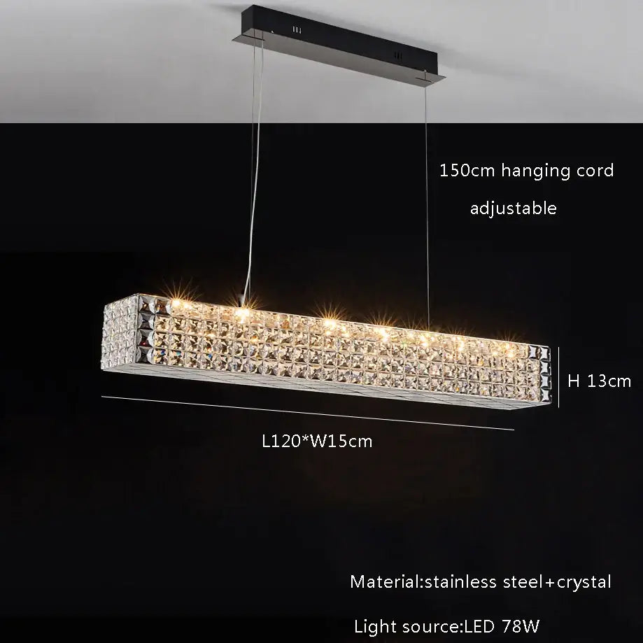 A sleek rectangular decorbites crystal chandelier with clear crystals in polished stainless steel for dining room lighting