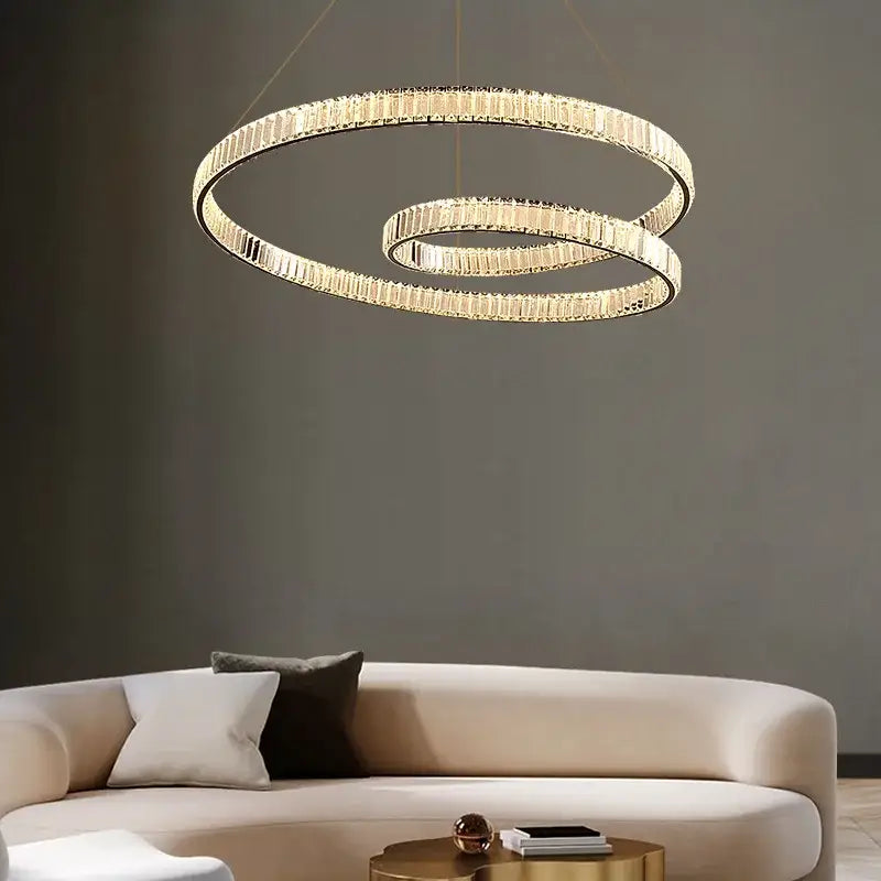 Gold-toned modern DecorBites™ crystal chandelier led light fixture with interlocking rings and faceted crystal accents
