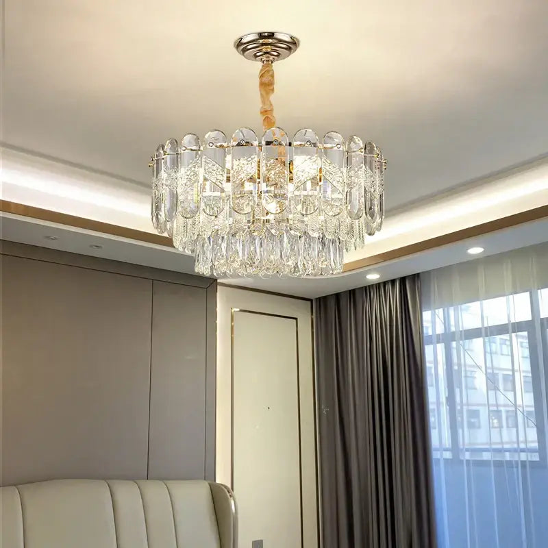 Modern decorbites crystal chandelier with polished chrome mount gold accents and cascading clear glass prisms