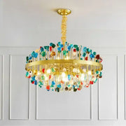 A vibrant decorbites crystal chandelier lighting fixture with a gold frame and colorful glass beads for dining rooms