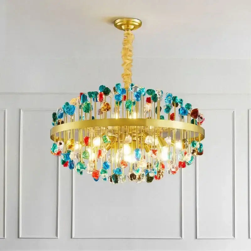 A vibrant decorbites crystal chandelier lighting fixture with a gold frame and colorful glass beads for dining rooms