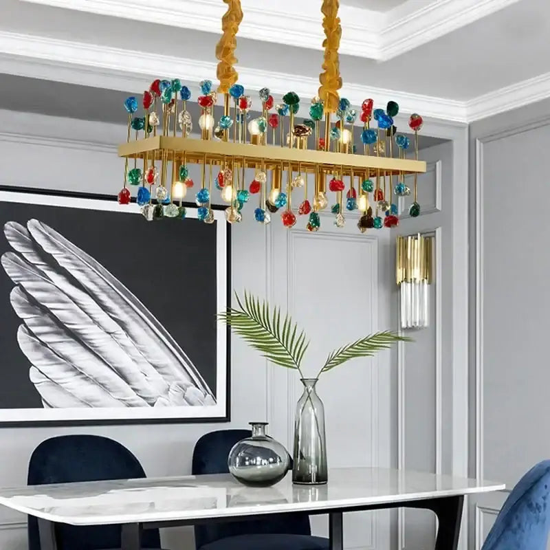 A vibrant decorbites crystal chandelier lighting fixture with gold frame and colorful glass orbs for dining room and kitchen island