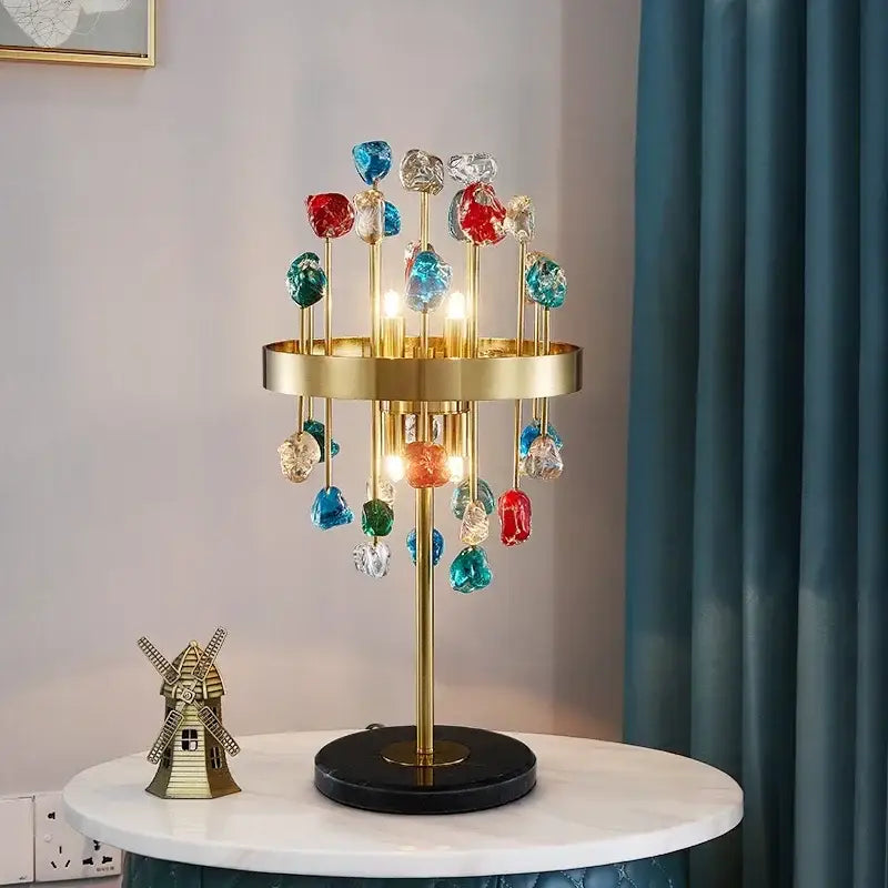 A vibrant decorbites crystal chandelier lighting fixture with gold metal frame and colorful glass accents for dining room