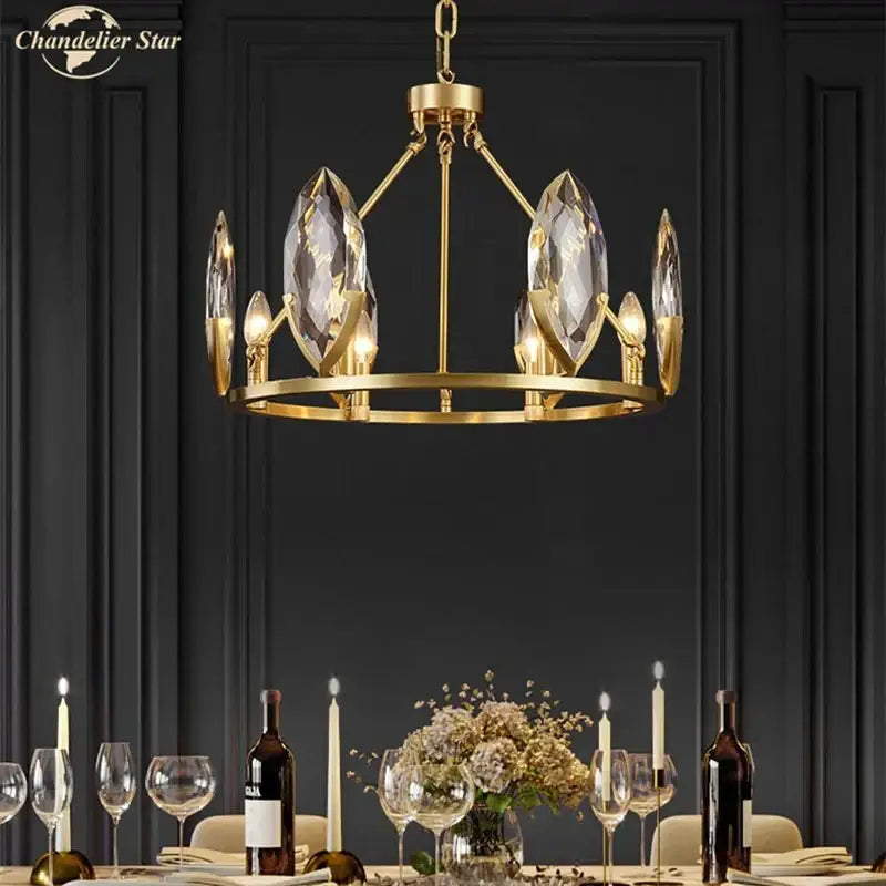 Gold-toned decorbites crystal chandelier with faceted crystal accents and circular frame for luxurious living spaces