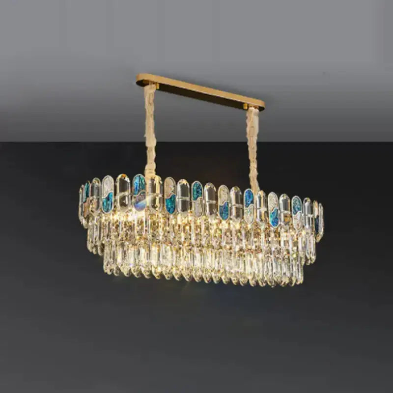 Elegant gold-toned decorbites crystal chandelier led lighting with cascading clear crystals and blue-tinged glass panels for living room