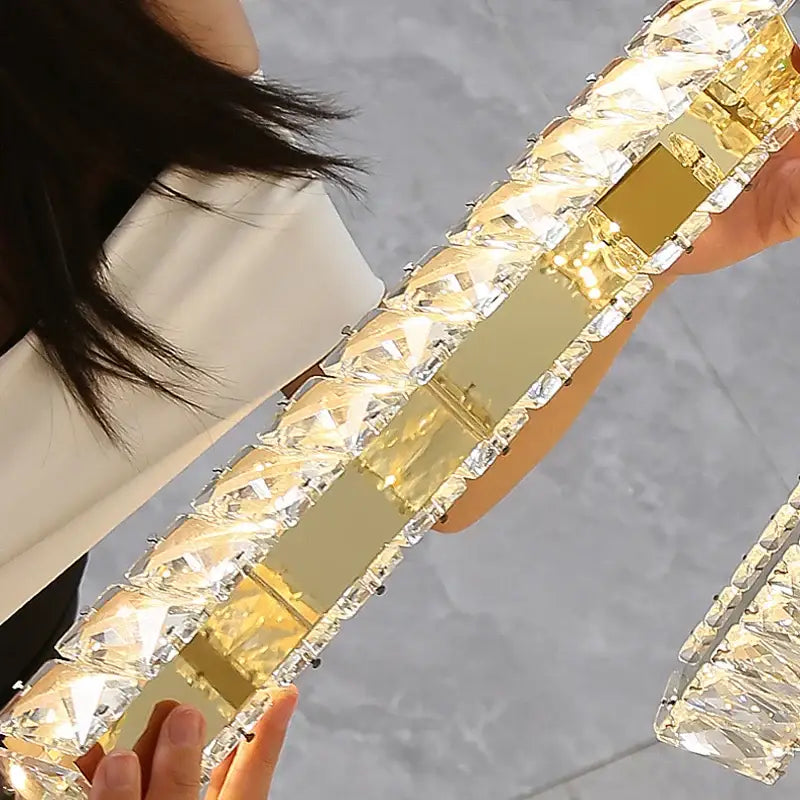 Gold-toned DecorBites crystal chandelier with rectangular crystals and mirrored panels for LED mezzanine dining lighting