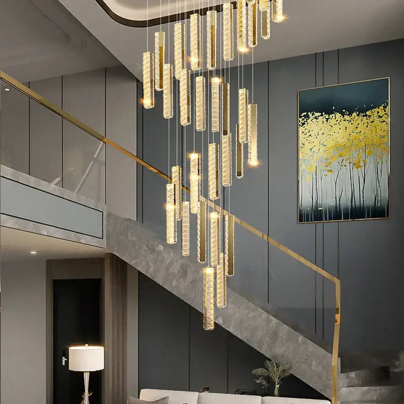 A decorbites crystal chandelier led with cascading golden cylindrical glass elements for mezzanine dining room lighting