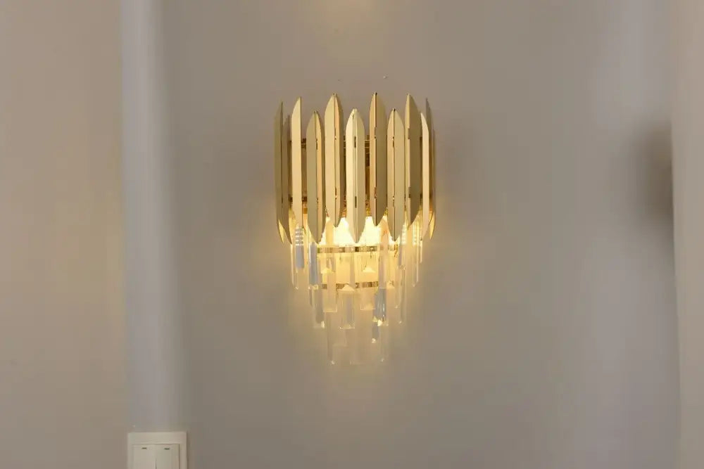 Gold-toned pendant light with vertical metallic blades and crystal droplets from decorbites crystal chandelier collection
