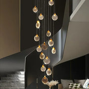 A decorbites crystal chandelier led pendant light with golden spherical glass orbs for modern duplex staircases