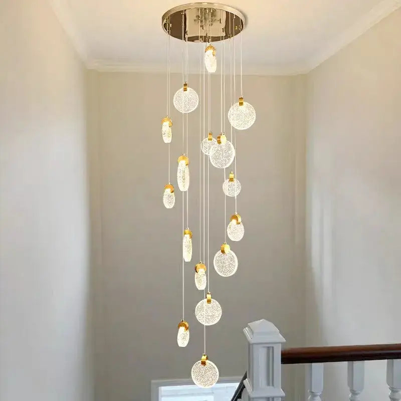 A modern decorbites crystal chandelier led pendant light with chrome mount and glass orbs for staircase lighting