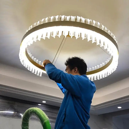 Modern gold-toned metal decorbites crystal chandelier led with clear faceted crystals in concentric rings for dining room decor
