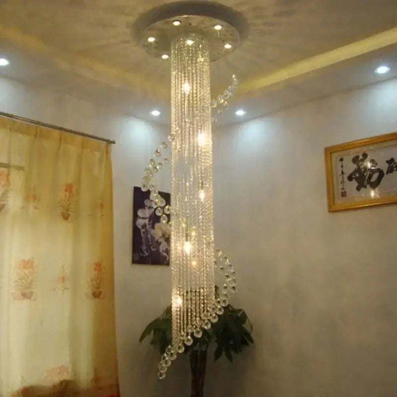 A tall elegant decorbites crystal chandelier with cascading clear glass beads and embedded LED lights for luxury decor