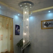 A tall, elegant decorbites crystal chandelier with spiral design and clear glass beads for luxury living room decor