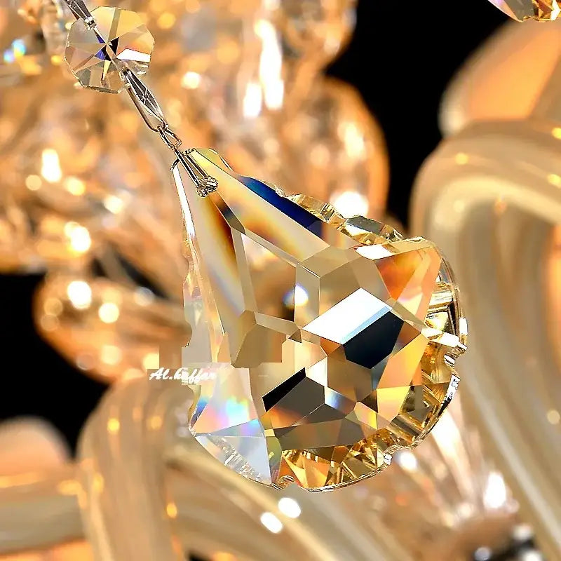 A faceted teardrop-shaped crystal pendant with a golden hue for decorbites crystal chandelier light fixtures