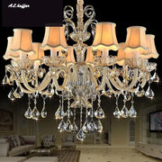 DecorBites crystal chandelier light with gold metal arms, teardrop crystals, and beige lampshades for luxury living rooms