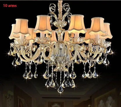 Decorbites crystal chandelier light featuring 10 gold-toned arms with crystal droplets and beige lampshades for luxury living