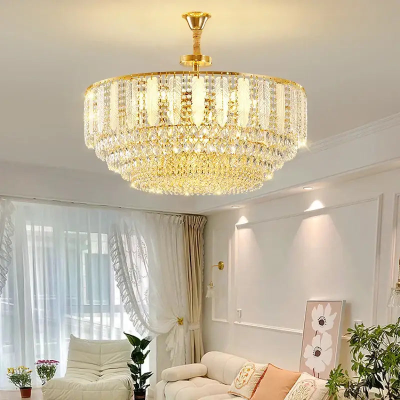 Decorbites crystal chandelier light featuring a gold-toned brass fixture and multiple tiers of faceted glass elements