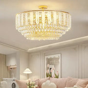 Gold-toned DecorBites crystal chandelier light with multiple tiers of faceted glass elements for elegant home decor