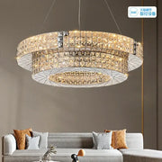 A modern double tiered decorbites crystal chandelier with warm golden lights and sleek metallic frame for luxury living room