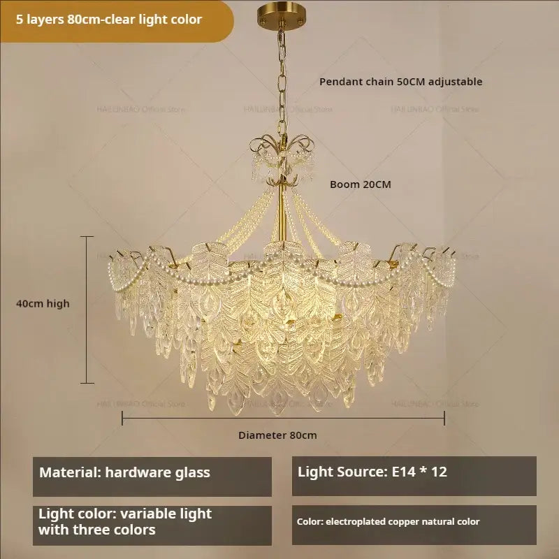 A luxurious gold-toned decorbites crystal chandelier light with crystal leaf designs and pearl strands for elegant interiors