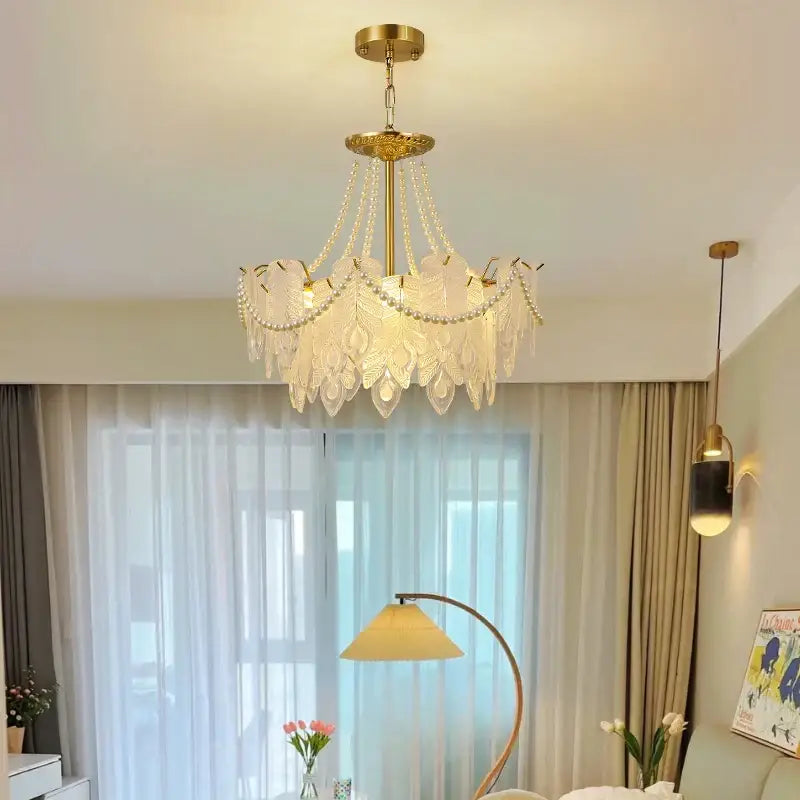 Elegant gold-toned DecorBites crystal chandelier with translucent leaf-shaped glass shades and dangling crystal beads for luxury lighting