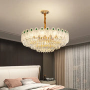 Decorbites crystal chandelier light with gold-toned stem, green gemstone accents, and cascading clear crystals for living room