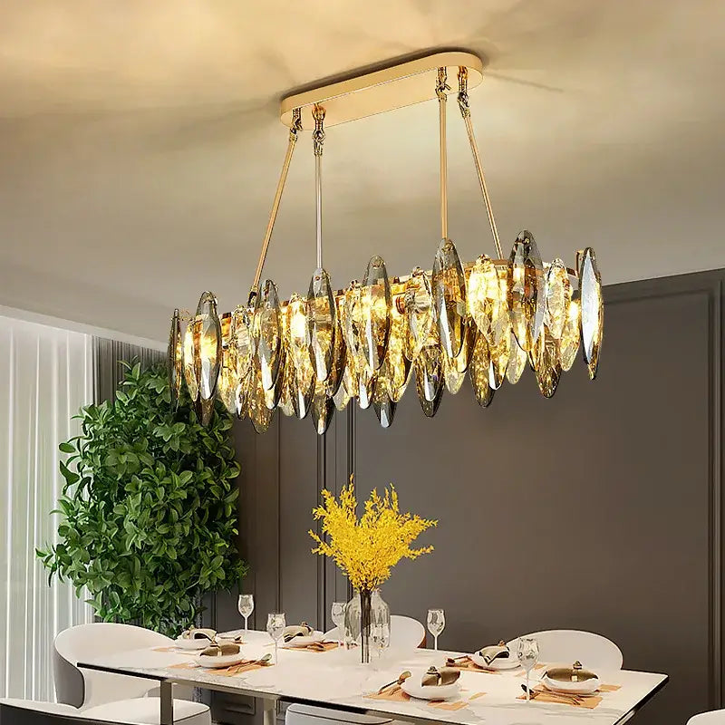 Gold-toned decorbites crystal chandelier light with elongated leaf-shaped crystal pendants for bedroom and living room
