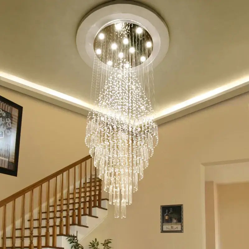 A modern decorbites crystal chandelier with cascading clear glass prisms and circular white ceiling mount for luxury decor