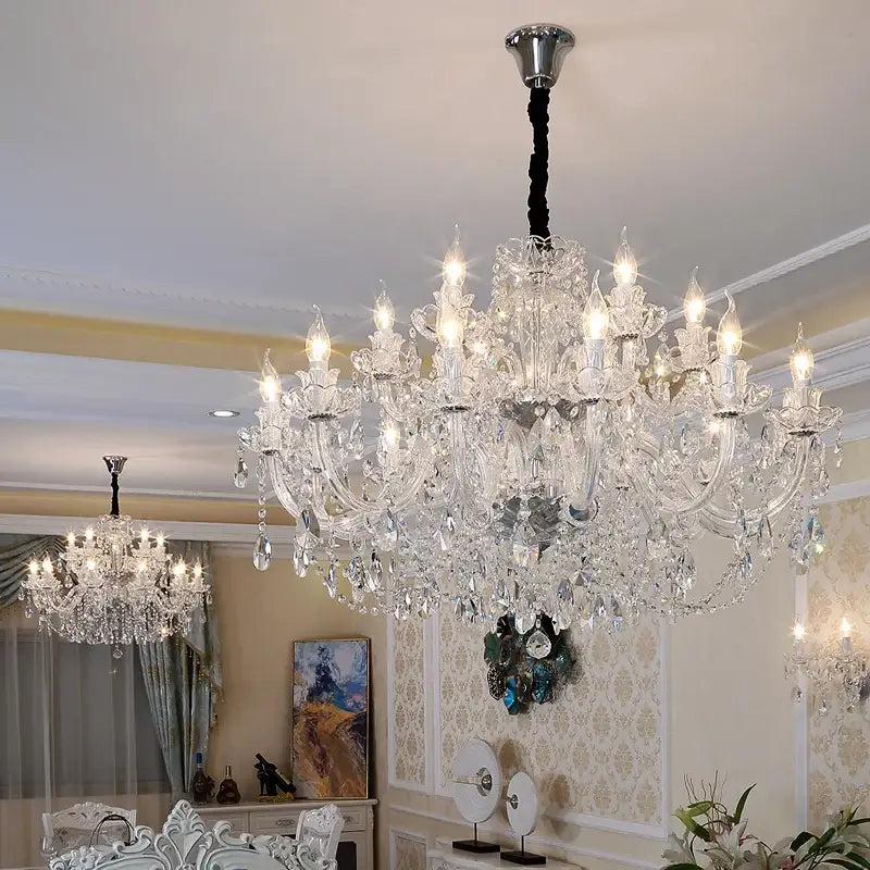 A decorbites crystal chandelier lighting with multiple arms and clear k9 teardrop crystals suspended by black cord