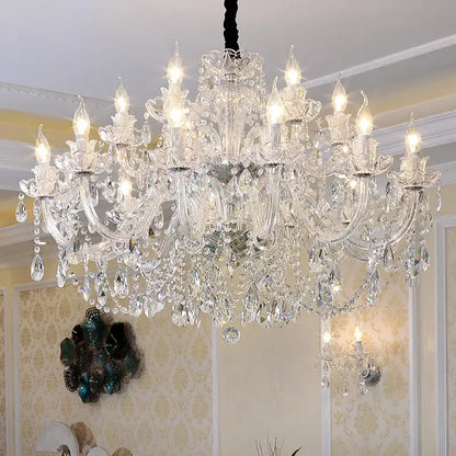 A decorbites crystal chandelier lighting with multi-tiered gold and silver arms and clear k9 teardrop crystals hanging