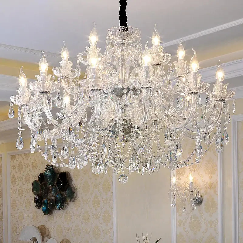 A decorbites crystal chandelier lighting with multi-tiered gold and silver arms and clear k9 teardrop crystals hanging