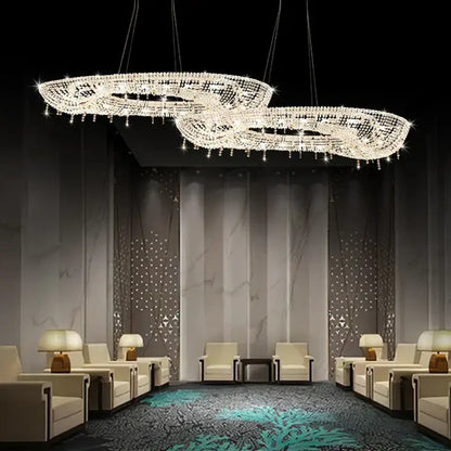 A decorbites crystal chandelier luminaire featuring two interlocking oval frames with clear crystal droplets